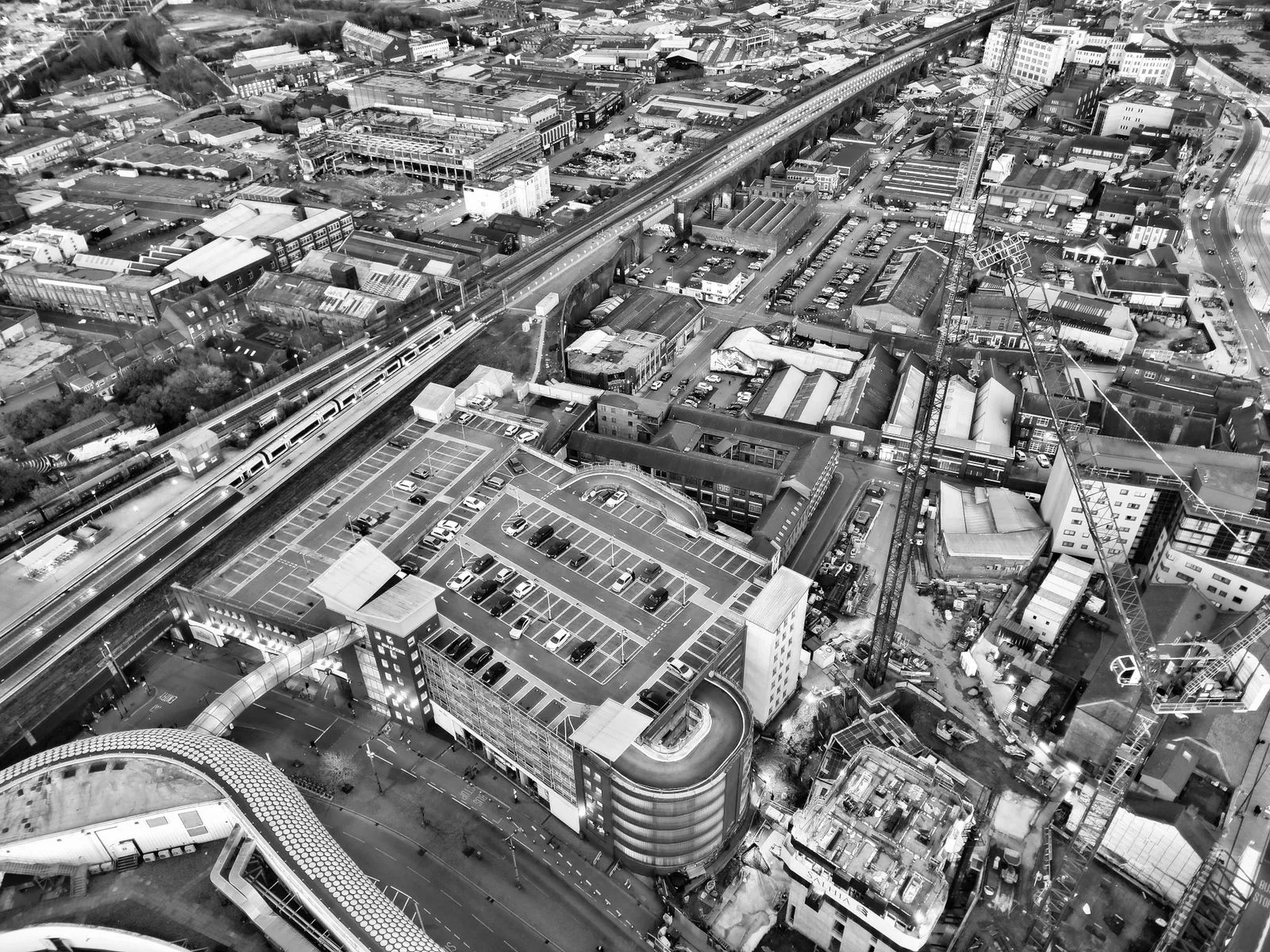 Black and white aerial view of Birmingham cityscape showcasing urban architecture and infrastructure.